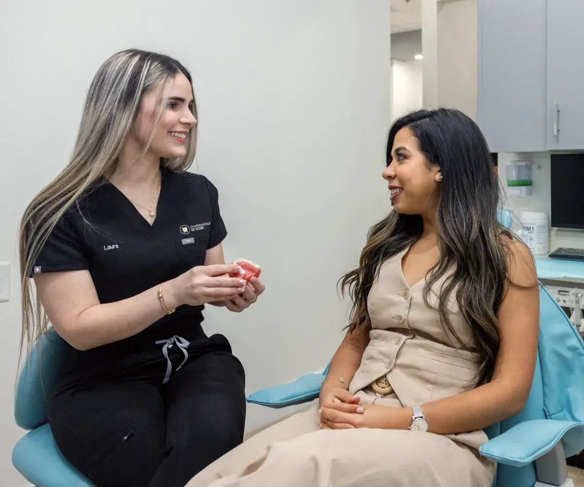 Friendly conversation between patient and team member at Charming Smiles