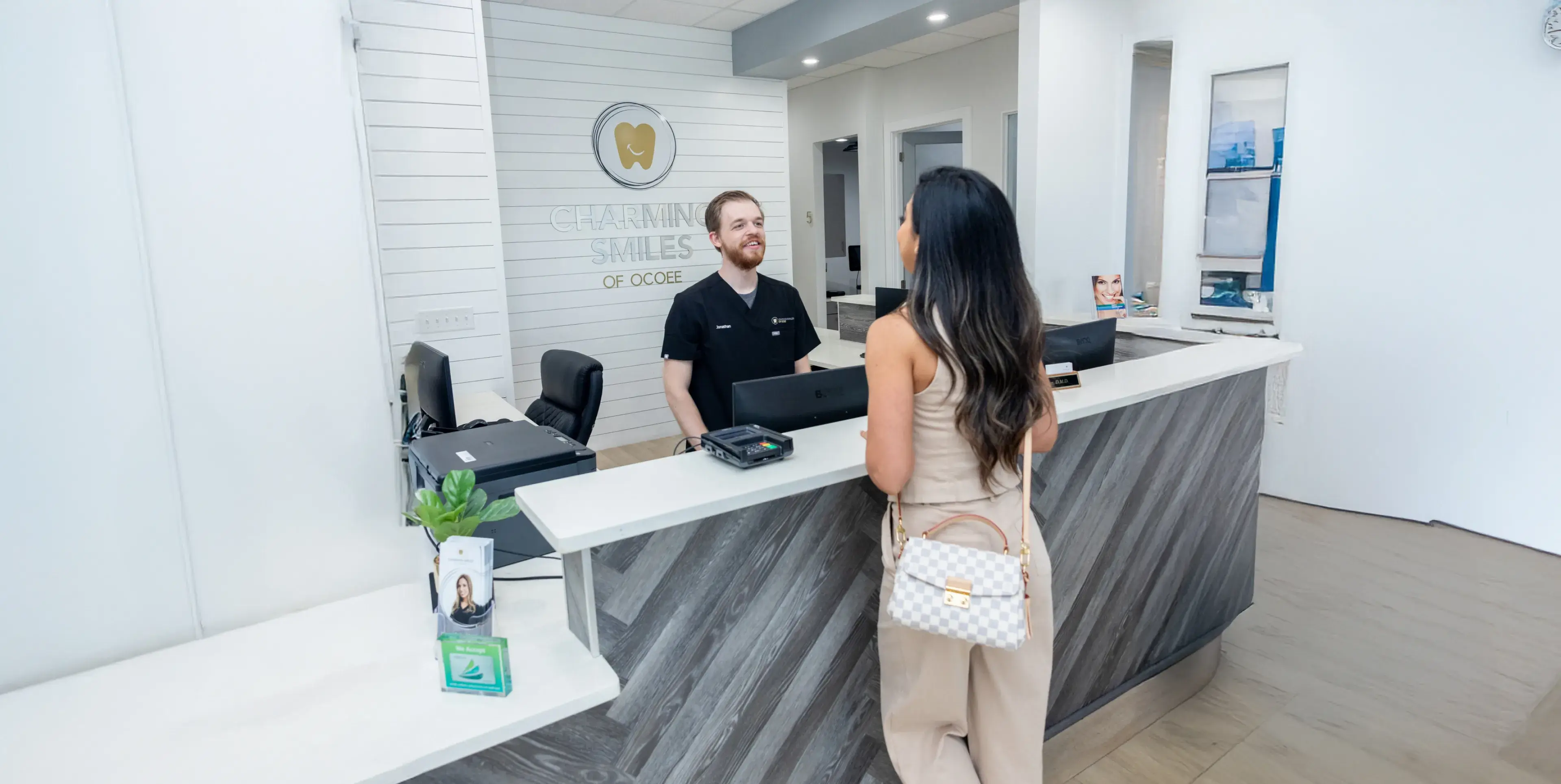 Patient and team member greeting at Charming Smiles of Ocoee front desk
