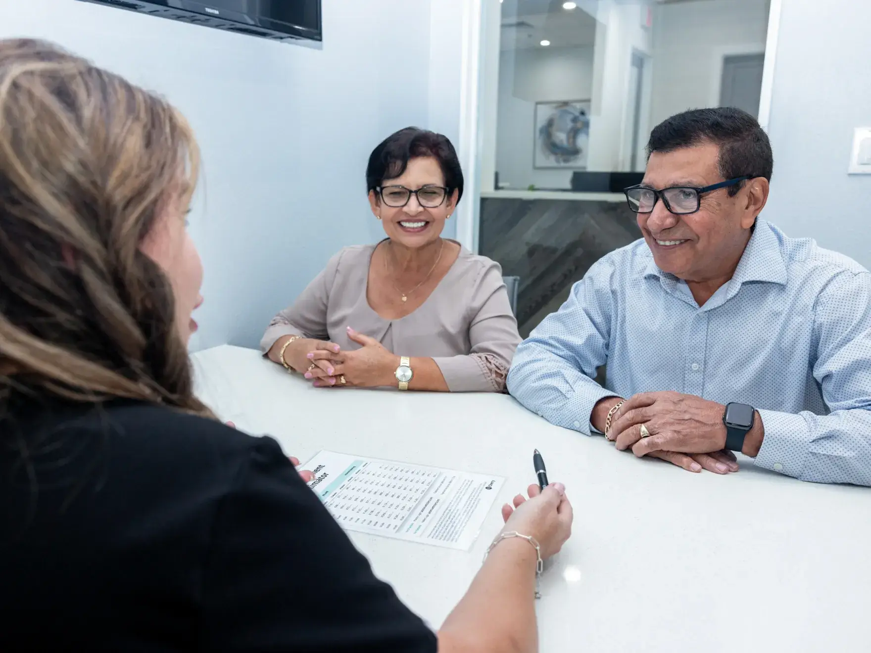 Patient discussing insurance and payment options with the Charming Smiles team