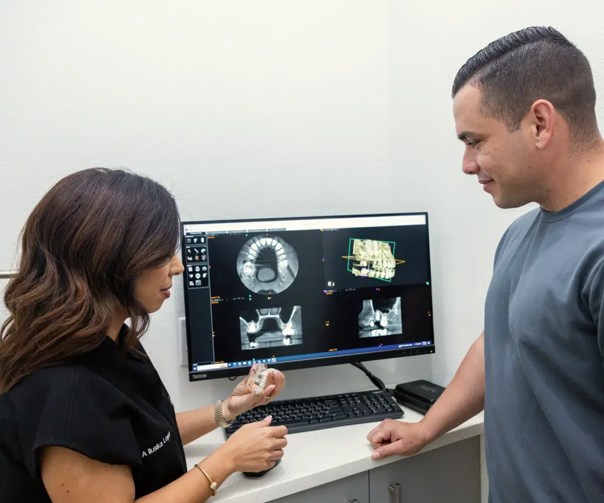 Patient reviewing dental implant plan with the team