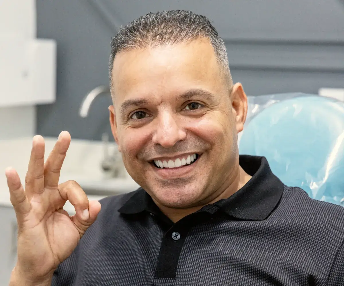 Patient with a beautiful smile after dental veneer treatment